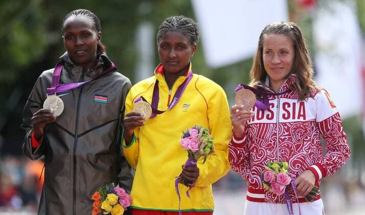 LONDON, Aug. 5, 2012 - Gold medalist Tiki Gelana (C) of Ethitopia, silver medalist Priscah Jeptoo (L) of Kenya, bronze medalist Tatyana Petrova Arkhipova of Russia attend awarding ceremony of women s marathon at London 2012 Olympic Games in London, Britain, August 5, 2012. 