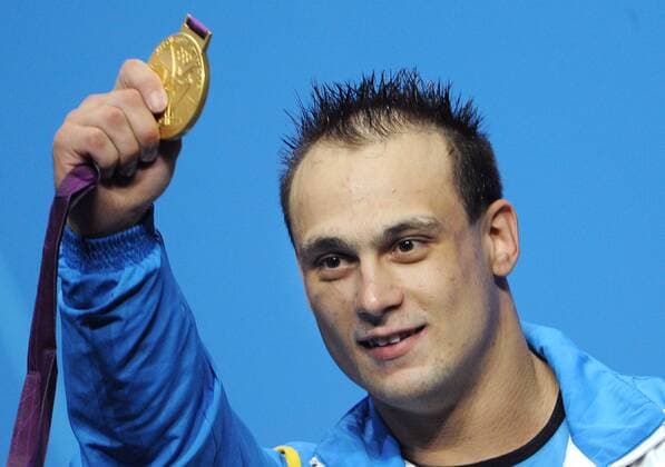 LONDON, GREAT BRITAIN. AUGUST 4, 2012. Ilya Ilyin of Kazakhstan celebrates during the Victory Ceremony after winning gold in the Men s 94kg Weightlifting at the London 2012 Olympic Games.  RE104EC0