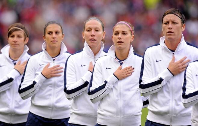 United States, (USA) Alex Morgan (2r) leads the singing of the National anthem.Canada v USA Olympic 2012 semi-final women s match at Old Trafford, Manchester United Kingdom on the 6th August 2012..Pic Simon Bellis SPORTIMAGE. EDITORIAL USE ONLY. No use with unauthorised audio, video, data, fixture lists, club league logos or live services. Online in-match use limited to 120 images, no video emulation. No use in betting, games or single club league player publications.