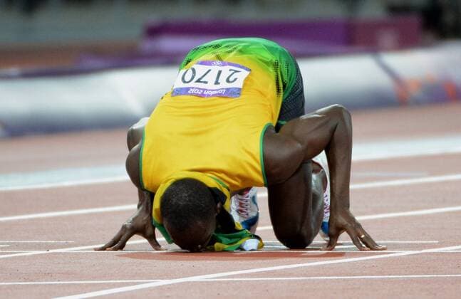 Jamaica s Usain Bolt kisses lane seven at the finish line as he celebrates his goldmedal in the Men s 200M Final at Olympic Stadium during the London 2012 Summer Olympics in Olympic Park in Stratford, London on August 9, 2012. .  OLY2012070809126