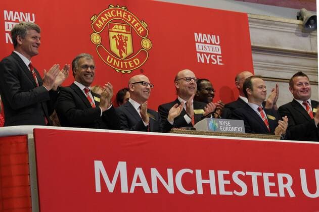Co-chairmen Avram Glazer, Joel Glazer and other executives ring the opening bell at the New York Stock Exchange on the day when Manchester United Lists its Initial Public Offering at the NYSE on Wall Street In New York City on August 10, 2012. Manchester United will begin trading today on the NYSE under the ticker symbol MANU.  NYP20120810121