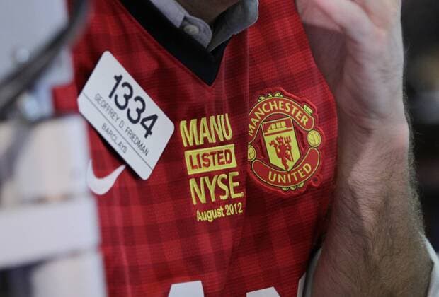 Barclays Traders wear the Manchester United Jersey at the New York Stock Exchange on the day when Manchester United Lists its Initial Public Offering at the NYSE on Wall Street In New York City on August 10, 2012. Manchester United will begin trading today on the NYSE under the ticker symbol MANU.  NYP20120810114