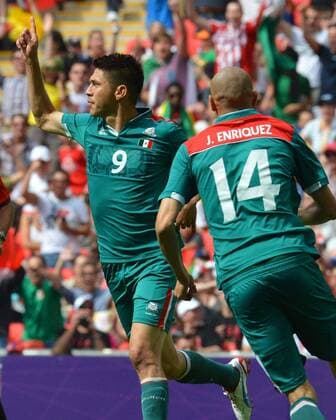 (120811) -- LONDON, Aug. 11, 2012 (Xinhua) -- Mexican players Oribe Peralta and Jorge Enriquez celebrate after scoring a goal during men s football gold medal match between Brazil and Mexico, at London 2012 Olympic Games in London, Britain, on August 11, 2012. (Xinhua Gong Lei) (nxl) (OLY2012)BRITAIN-LONDON-FOOTBALL-MEN 
