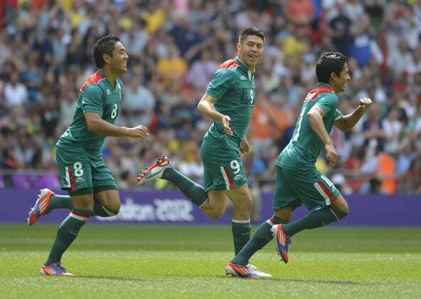 Marco Fabian (L-R) Oribe Peralta and Javier Aquino of Mexico celebrate Paralta s goal during the first half of the Gold Medal Football Match against Brazil at the London 2012 Summer Olympics on August 11, 2012 at Wembley Stadium, London.  OLY20120811403