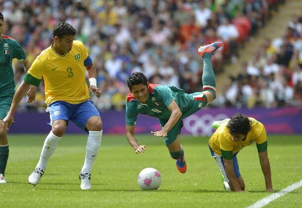 Defender Thiago Silca of Brazil (L-R), midfielder Javier Aquino of Mexico and defender Rafael of Brazil go for the ball during the first half of the Gold Medal Football Match at the London 2012 Summer Olympics on August 11, 2012 at Wembley Stadium, London.  OLY20120811405