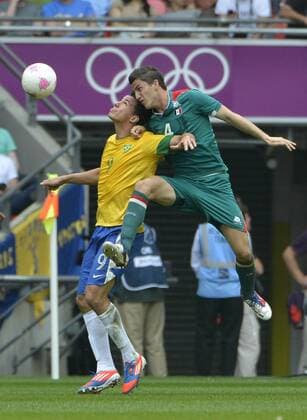 Forward Leandro Damiao of Brazil and defender Hiram Mier of Mexico go for the ball during the first half of the Gold Medal Football Match at the London 2012 Summer Olympics on August 11, 2012 at Wembley Stadium, London.  OLY20120811411