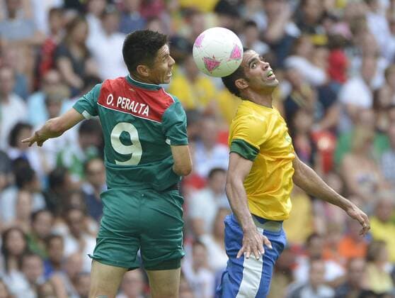 forward Oribe Peralta of Mexico and midfielder Sandro of Brazil go for the ball during the first half of the Gold Medal Football Match at the London 2012 Summer Olympics on August 11, 2012 at Wembley Stadium, London.  OLY20120811412