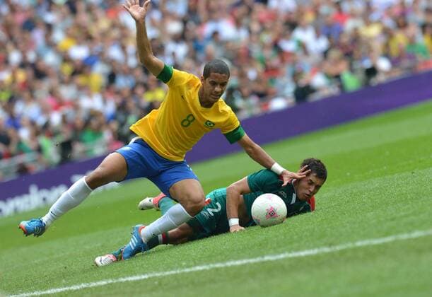 (120811) -- LONDON, Aug. 11, 2012 (Xinhua) -- Sandro Raniere Guimaraes Cordeiro (L) of Brazil vies for the ball during men s football gold medal match between Brazil and Mexico, at London 2012 Olympic Games in London, Britain, on August 11, 2012. Mexico won the match 2-1 and won gold medal. (Xinhua Gong Lei) (zgp) (OLY2012)BRITAIN-LONDON-MEN S FOOTBALL-GOLD 