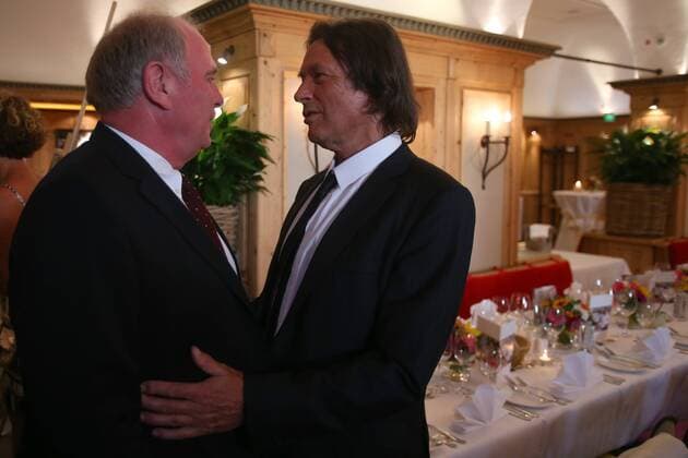 MUNICH, GERMANY - AUGUST 16: Hans-Wilhelm Müller Wohlfahrt (R) welcomes Uli Hoeness, president of FC Bayern München during Hans-Wilhelm Müller Wohlfahrts 70th birthday celebration at Seehaus on August 16, 2012 in Munich, Germany - Local Caption Hans-Wilhelm Müller Wohlfahrt; Uli Hoeness 