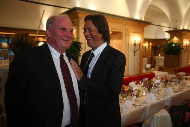 MUNICH, GERMANY - AUGUST 16: Hans-Wilhelm Müller Wohlfahrt (R) welcomes Uli Hoeness, president of FC Bayern München during Hans-Wilhelm Müller Wohlfahrts 70th birthday celebration at Seehaus on August 16, 2012 in Munich, Germany - Local Caption Hans-Wilhelm Müller Wohlfahrt; Uli Hoeness 