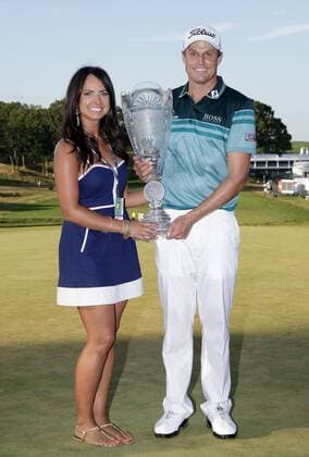 Nick Watney and wife Amber hold up the Championship Trophy after the final round of The Barclays 2012 FedExCup Playoffs at The Black Course at Bethpage State Park in Farmingdale, New York on August 26, 2012. Watney wins with a score of 10 under par.  NYP20120826125
