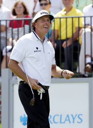 Phil Mickelson reacts to the fans applause while walking on the first tee box in the final round of The Barclays 2012 FedExCup Playoffs at The Black Course at Bethpage State Park in Farmingdale, New York on August 26, 2012.  NYP20120826102