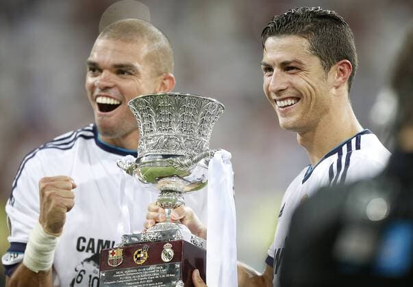 Real Madrid s Pepe and Cristiano Ronaldo celebrate with trophy after Super Cup match. August 29, 2012.  (2012082933120)