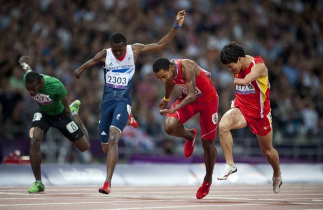 Gold medalist Zhao Xu (R) of China celebrates after the men s 100 T46 final at the London 2012 Paralympic Games in London, Britain, on Sept. 6, 2012. (Xinhua Lui Siu Wai) BRITAIN-LONDON-PARALYMPIC GAMES-ATHLETCIS 