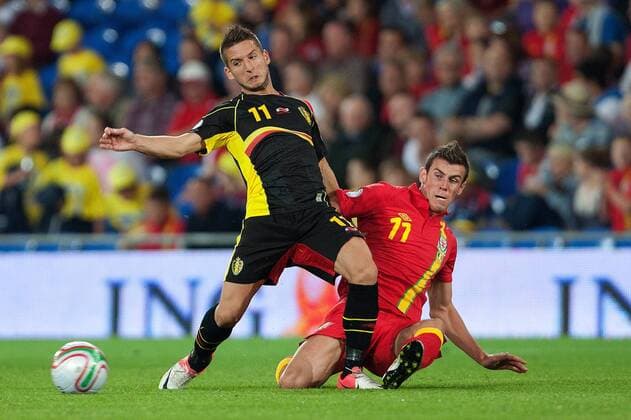 Football - World Cup 2014 Qualifier - Wales vs. Belgium Gareth Bale of Wales challenges Dries Mertens of Belgium at the Cardiff City Stadium 
