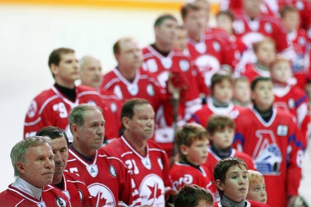 Hockey players observe a minute s silence during a Russia vs Canada memorial hockey match in Yaroslavl. The game commemorates an anniversary of the September 2011 plane crash in which 38 members of the HC Lokomotiv Yaroslavl hockey team and coaching staff died.  RE107BE1
