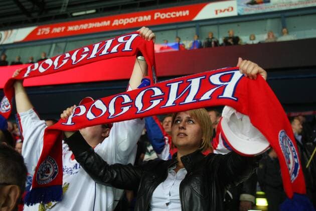 Fans hold up scarves reading RUSSIA memorial hockey match in Yaroslavl. The game commemorates an anniversary of the September 2011 plane crash in which 38 members of the HC Lokomotiv Yaroslavl hockey team and coaching staff died.  RE107BE2