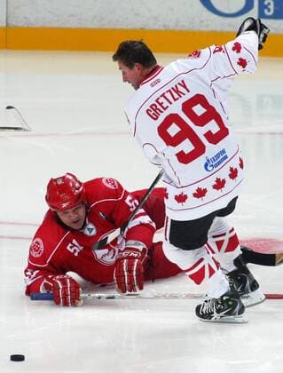 Russia s Andrei Kovalenko (L) and Canada s Wayne Douglas Gretzky in a Russia vs Canada memorial hockey match in Yaroslavl. The game commemorates an anniversary of the September 2011 plane crash in which 38 members of the HC Lokomotiv Yaroslavl hockey team and coaching staff died.  RE107C1D