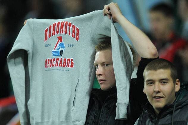 A fan holds up a sweatshirt with the HC Lokomotiv Yaroslavl logo during a 2014 FIFA World Cup Group F qualifying football match between Russia and Northern Ireland at Lokomotiv Stadium. Russia won 2-0.  RE107C23