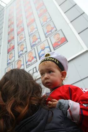 YAROSLAVL, RUSSIA. SEPTEMBER 7, 2012. A mother with a child during a memorial event for the Lokomotiv Yaroslavl hockey players and coaching staff who died in the September 2011 plane crash near Yaroslavl.  RE107B82