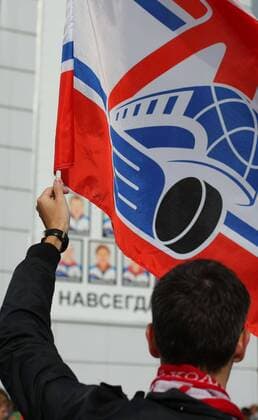 YAROSLAVL, RUSSIA. SEPTEMBER 7, 2012. Fan waves a flag outside the Arena 2000 Stadium during a memorial event for the Lokomotiv Yaroslavl hockey players and coaching staff who died in the September 2011 plane crash near Yaroslavl.  RE107BA5