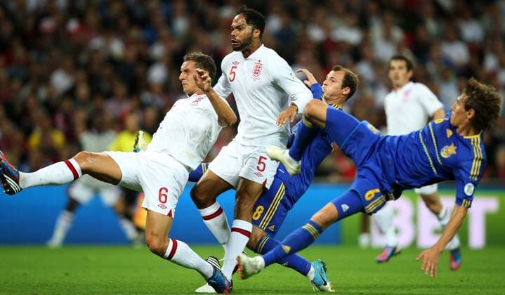 LONDON, Sept. 11, 2012 -- Phil Jagielka (1st L) and Joleon Lescott (2nd L) of England vie with Roman Zozulia(2nd R) and Phil Jagielka of Ukraine during the FIFA 2014 World Cup Group H qualifying match between England and Ukraine at Wembley Stadium in London, Britain, on Sept. 11, 2012. The match ended with a 1-1 draw. (Xinhua Wang Lili) BRITAIN-LONDON-SOCCER-WORLD CUP QUALIFIER-ENG VS UKR 