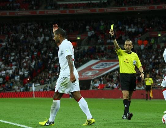 England v Ukraine - World Cup Qualifier Group H . . 11.09.12 Glen Johnson (E) is given a yellow card by referee Cuneyt Cakir. 