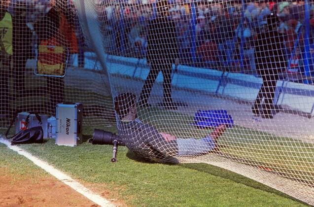 Hillsborough Disaster . . 15.04.1989 FA Cup Semi-Final - FC Liverpool v Nottingham Forest FC. A photographer slums on the back of the net at the Kop end. The FA Cup semi-Final between Liverpool and Nottingham Forest was stopped after six minutes of the game. 96 supporters in the Liverpool end at Leppings Lane died in the disaster after being crushed. South Yorkshire police were on duty at the match. The game was played at the neutral ground of Hillsborough, home of Sheffield Wednesday. 