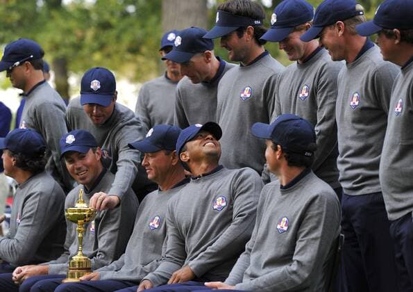 Tiger Woods (C) smiles as the United State teammates gather for a photo at the 39th Ryder Cup at Medinah Country Club on Tuesday, September 25, 2012 in Medinah, Illinois. Ryder Cup tournament play begins Friday.  BKX2012092533