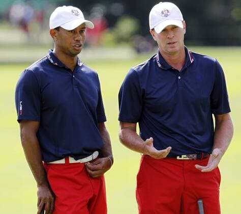 United States team members Tiger Woods (L) and Steve Stricker chat while on the ninth green during the second day of practice rounds at Medinah Country Club, site of the 39th Ryder Cup matches September 26, 2012 in Medinah, Illinois.  MED2012092652