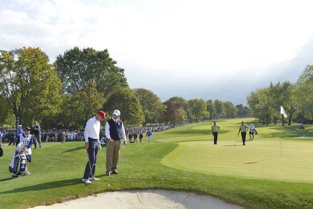 Team USA s Jim Furyk (L) talks with an official to get a ruling on the 10th hole at the 39th Ryder Cup at Medinah Country Club on September 28, 2012 in Medinah, Illinois.  BKX2012092829