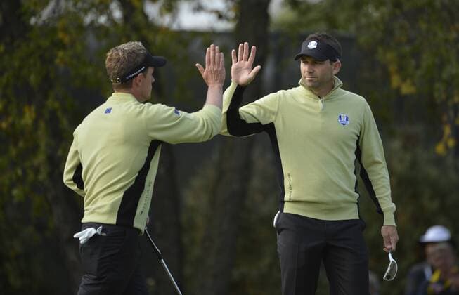 Team Europe s Luke Donald of England (L) high-fives teammate Sergio Garcia of Spain after a birdie putt on the 10th hole at the 39th Ryder Cup at Medinah Country Club on September 28, 2012 in Medinah, Illinois.  BKX2012092832