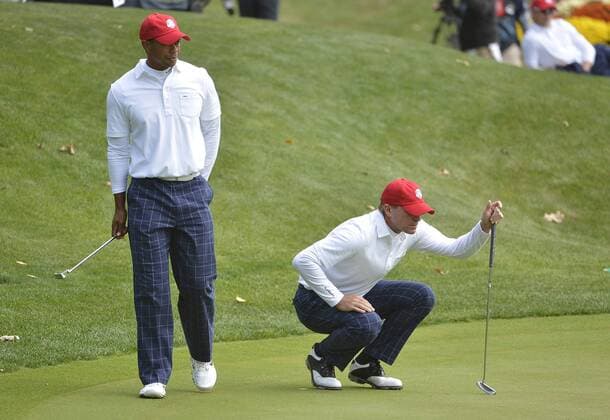 Team USA s Tiger Woods (L) and teammate Steve Stricker line up their putts at the 39th Ryder Cup at Medinah Country Club on September 28, 2012 in Medinah, Illinois.  BKX2012092858