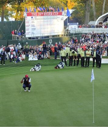 Team USA s Tiger Woods (L) lines up a birdie putt on the 18th green at the 39th Ryder Cup at Medinah Country Club on September 28, 2012 in Medinah, Illinois.  BKX2012092889