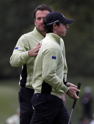 Sept. 28, 2012 - Medinah, IL, USA - European Ryder Cup Team member Graeme McDowell, left, taps the back of teammate Rory McIlroy after McIlroy makes a putt on the seventh hole on the first day of competition at the 2012 Ryder Cup at Medinah Country Club in Medinah, Illinois, Friday, September 28, 2012. 2012 Ryder Cup - ZUMAm67