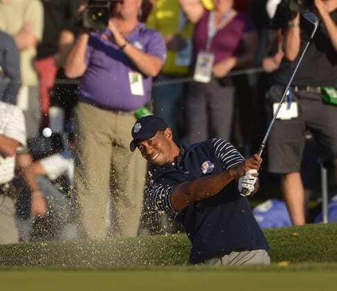 Team USA s Tiger Woods hits out of a bunker and onto the 15th green at the 39th Ryder Cup at Medinah Country Club on September 29, 2012 in Medinah, Illinois. After the second day of play the United States leads Europe 10-6 and needs 4 1 2 points in the final round to win the Ryder Cup.  BKX2012092957