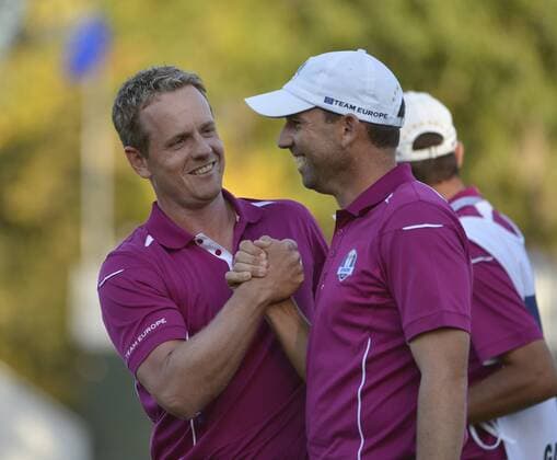 Team Europe s Sergio Garcia of Spain (R) teammate Luke Donald of England shake hands after Donald sunk a birdie putt to win the 15th hole at the 39th Ryder Cup at Medinah Country Club on September 29, 2012 in Medinah, Illinois. After the second day of play the United States leads Europe 10-6 and needs 4 1 2 points in the final round to win the Ryder Cup.  BKX2012092960
