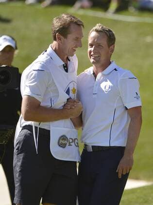 Team Europe s Luke Donald of England (R) shakes hands with his caddie after winning his match on the the 17th hole during the singles matches at the 39th Ryder Cup at Medinah Country Club on September 30, 2012 in Medinah, Illinois. Donald defeated Team USA s Bubba Watson 2 and 1 to win a point for Team Europe.  CHI2012093014