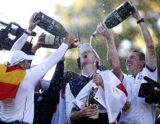 Team Europe s Justin Rose, of England, is doused with champaign after Europe came from behind to defeat the USA 14 1 2 to 13 1 2 at the 39th Ryder Cup at Medinah Country Club on September 30, 2012 in Medinah, Illinois.  MED2012093008