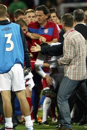 16.10.2012 Krusevac(Serbia) Serbia-England UEFA Under 21 Euro qualify play off men s football After match someone from Serbian players the crowd fist strikes to the head England football player Thomas Ince (central with number 10) beside Dejan Govedarica(central up) Serbian U21 assistant coach.While Ognjen Mudrinski(2nd from left with half-visible head) knee strikes in the stomach to Thomas Ince(central down) England 