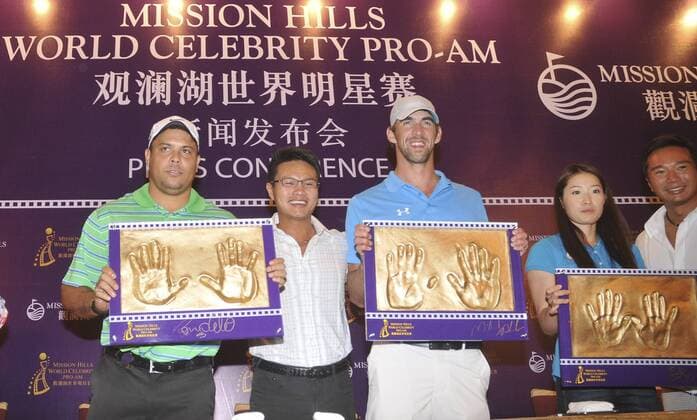 HAIKOU, CHINA - OCTOBER 18: (CHINA OUT) (L - R) Ronaldo Nazario of Brazil, Mission Hills Group Chairman Zhu Dingjian, Michael Phelps of USA and Chinese swimmer Luo Xuejuan attend Mission Hills Star Trophy press conference at the Mission Hills Golf Club on October 18, 2012 in Haikou, Hainan Province of China.  CFP432776871 