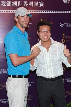 HAIKOU, CHINA - OCTOBER 18: (CHINA OUT) Michael Phelps of USA and Mission Hills Group Chairman Zhu Dingjian (R) attend Mission Hills Star Trophy press conference at the Mission Hills Golf Club on October 18, 2012 in Haikou, Hainan Province of China.  CFP432776895 