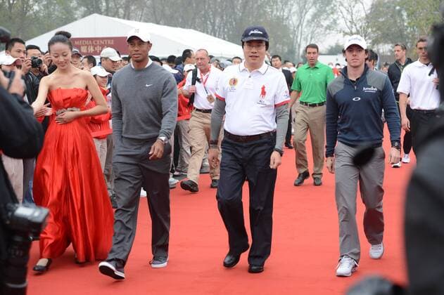 Golfers Tiger Woods of the United States, front third right, Rory McIlroy of Northern Ireland, front right, and guests arrive for a ceremony for a golf exhibition match in Zhengzhou city, central Chinas Henan province, 29 October 2012.  20121029_74217