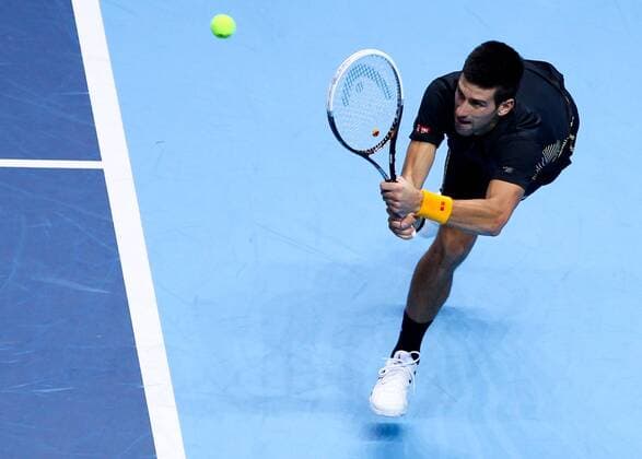 Novak Djokovic of Serbia returns a shot during the men s singles match at the ATP Tennis Herren World Tour Finals in the O2 Arena in London, Britain, on Nov. 9, 2012. (Xinhua Tang Shi) BRITAIN-LONDON-TENNIS-ATP-FINALS-DJOKOVIC-BERDYCH 