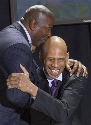 Nov. 16, 2012 - Los Angeles, California, U.S. - Former Los Angeles Laker EARVIN MAGIC JOHNSON (L) kisses former teammate KAREEM ABDUL-JABBAR before the unveiling of Abdul-Jabbar s statue in front of Staples Center. Kareem Abdul-Jabbar Statue Unveiled At Staples Center - ZUMAc68
