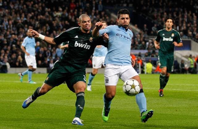 Sergio Kun Agüero (R) of Manchester City in action with Pepe of Real Madrid..Champions League football match between Manchester City and Real Madrid at the Etihad Stadium, Manchester on the 21st November 2012.. - EDITORIAL USE ONLY. No use with unauthorised audio, video, data, fixture lists, club league logos or live services. Online in-match use limited to 120 images, no video emulation. No use in betting, games or single club league player publications.