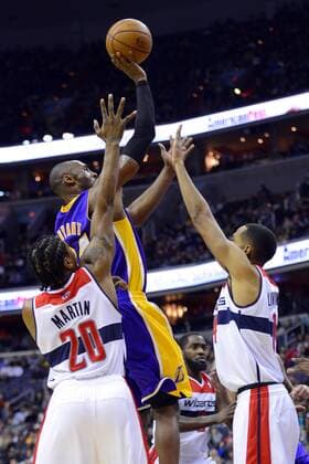 March 7, 2012 - Washington, DC, USA - Los Angeles Lakers shooting guard Kobe Bryant (24) lofts up a shot over Washington Wizards power forward Cartier Martin (20) and Wizards point guard Shaun Livingston (14) during the first half at the Verizon Center in Washington, D.C., Friday, December 14, 2012. Los Angeles Lakers vs Washington Wizards - ZUMAm67