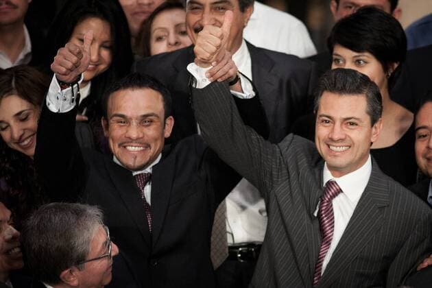 Mexican President Enrique Pena Nieto (R) and Mexican boxer Juan Manuel Marquez (L) cheer during a ceremony at the National Palace, in Mexico City, capital of Mexico, on Dec. 14, 2012. The welterweight champion Juan Manuel Marquez presented Pena Nieto the gloves he used on the match he won against Filipino boxer Manny Pacquiao as a gift. (Xinhua Pedro Mera) (ce) MEXICO-MEXICO CITY-BOXING-PENA NIETO-MARQUEZ 
