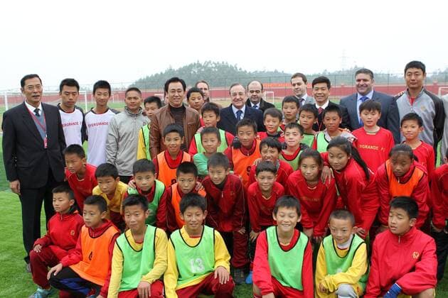 QINGYUAN, CHINA - DECEMBER 27: (CHINA OUT) Guangzhou Evergrande owner Xu Jiayin and Real Madrid president Florentino Perez visit Evergrande-Real Madrid Football School on December 27, 2012 in Qingyuan, Guangdong Province of China. Florentino Perez and his delegation are on a multi-day visit to Guangzhou Evergrande FC, who has a cooperation agreement with Real Madrid that has led to the creation of a football school in Qingyuan.  CFP434875699 