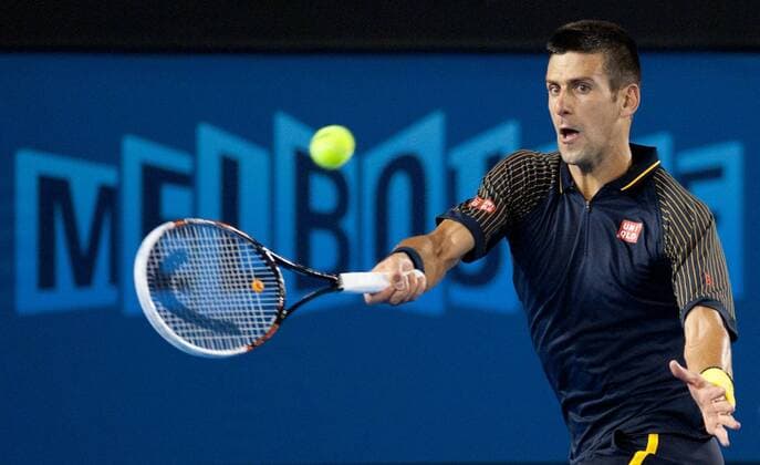 Novak Djokovic of Serbia hits a return during his fourth round men s singles match on the seventh day of 2013 Australian Open tennis tournament in Melbourne, Australia, Jan. 20, 2013. Novak Djokovic won 3-2. (Xinhua Bai Xue) (ql) AUSTRALIA-MELBOURNE-TENNIS-MEN S SINGLES 
